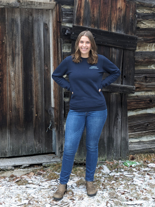 Outdoorsy Miss Adventures embroidered in ice blue thread on upper left chest of navy blue crew neck bamboo sweatshirtSmall Town Natural model Morgan is wearing a Unisex size Small. She typically wears a size Medium in Women's sweatshirts.