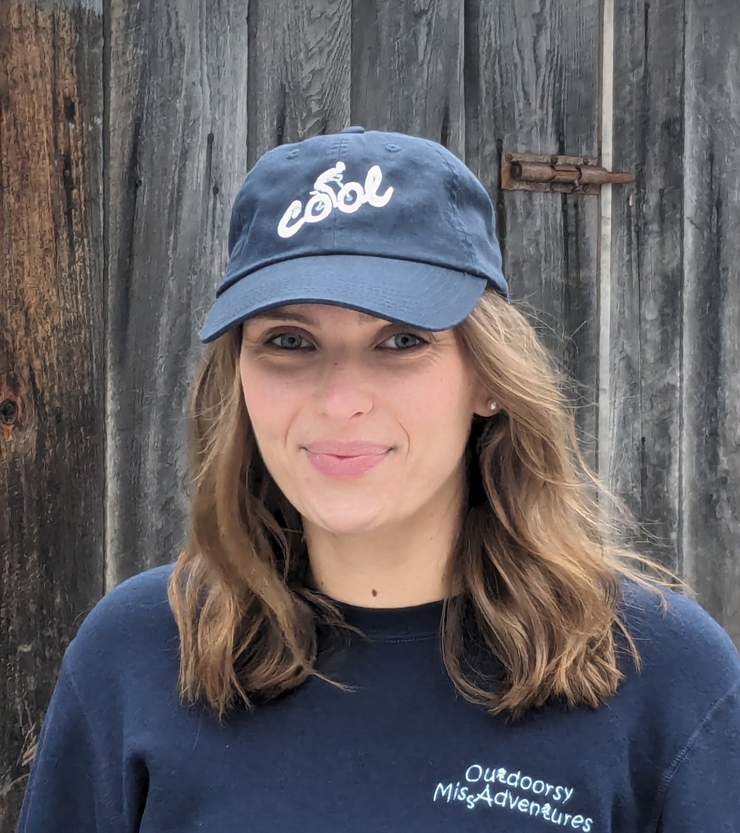 Cool fat biker embroidered in ice blue thread on navy blue hat with curved peak