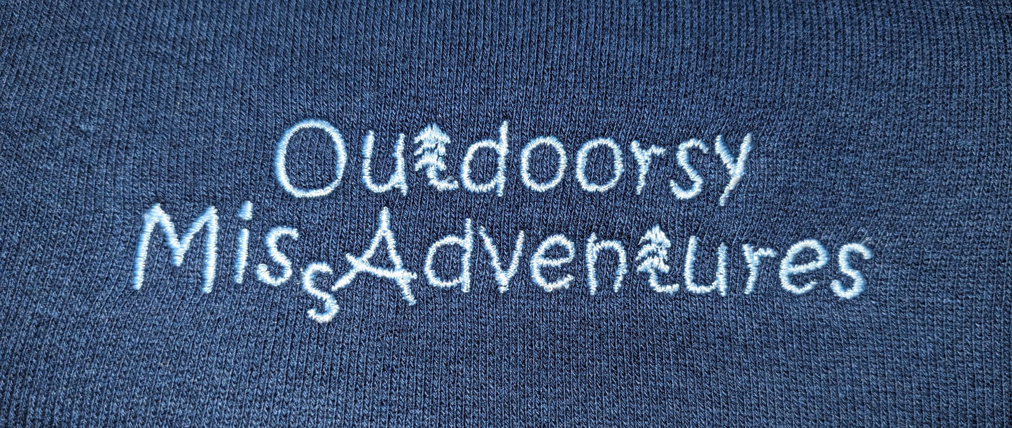 close up of embroidery on Outdoorsy Miss Adventures Three End Bamboo Fleece Crew Neck Sweatshirt colour= navy Embroidery= very light blue