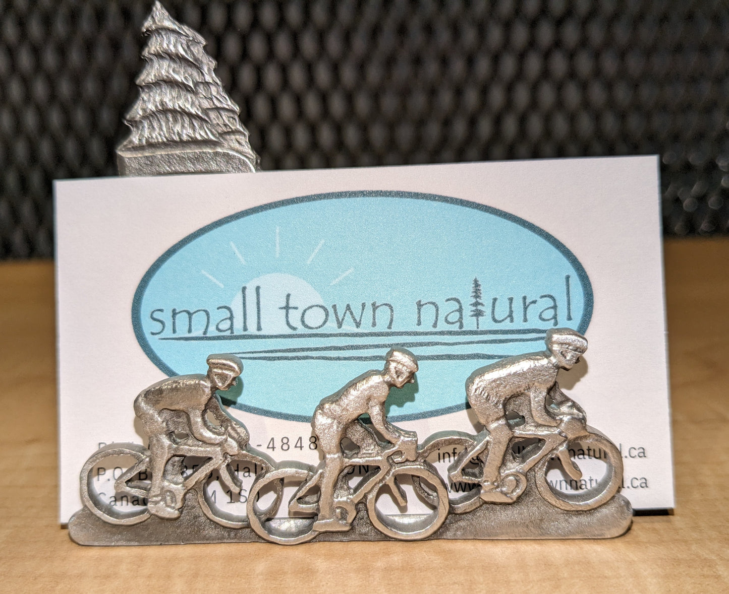 Small Town Natural now carries this beautiful business card holder that depicts a scene of three cyclists on a ride with a couple spruce trees in the background. Great for any cycling biz or the cycling enthusiasts work or office desk. All pewter. Handmade in Ontario Canada since 1972